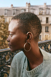 A model wearing the Estel Pressed Hoop Earring in colour Gold (Metallics), from the front, showing the whole outfit