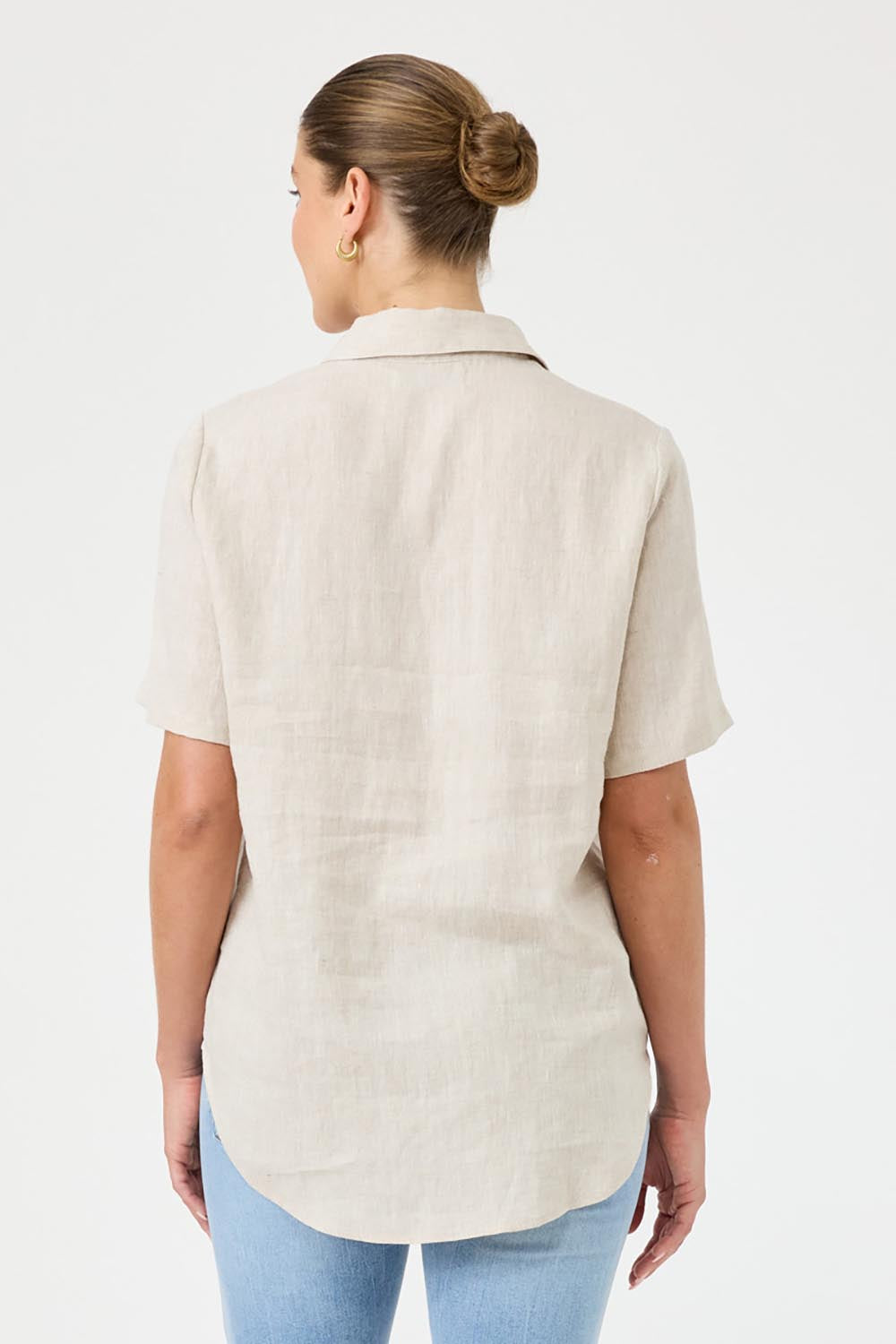 A model wearing the Studio Linen Short Sleeve Shirt in colour Dune, from the back