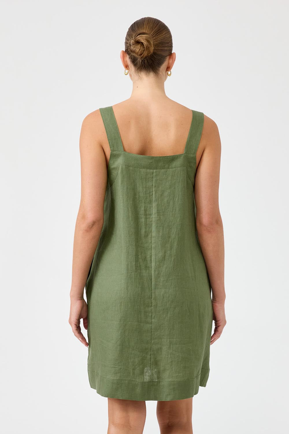 A model wearing the Studio Linen Short Tank Dress in colour Khaki (Green), from the back