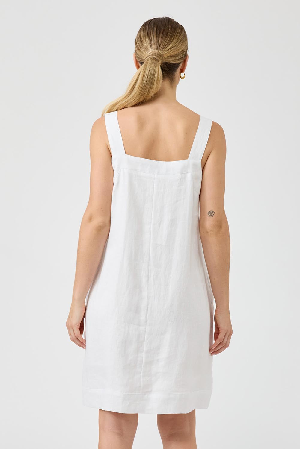 A model wearing the Studio Linen Short Tank Dress in colour White (White), from the back