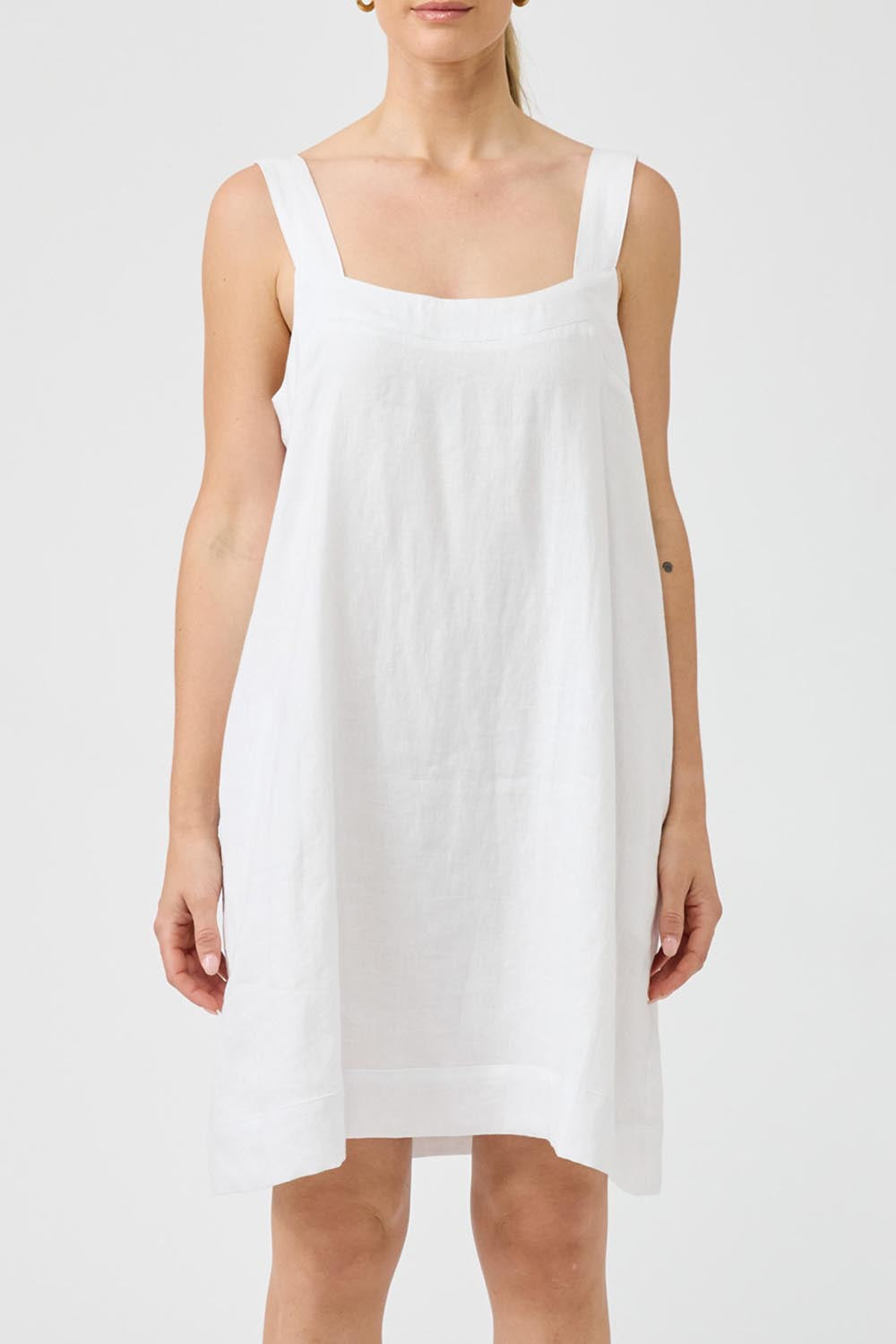 A model wearing the Studio Linen Short Tank Dress in colour White (White), from the front, cropped image