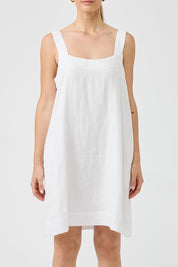 A model wearing the Studio Linen Short Tank Dress in colour White (White), from the front, cropped image