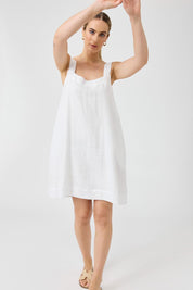 A model wearing the Studio Linen Short Tank Dress in colour White (White), from the front, showing the whole outfit