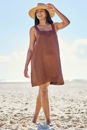Model Eshan wearing size 10 of the Studio Linen Short Tank Dress – Chocolate in colour Chocolate, from the front