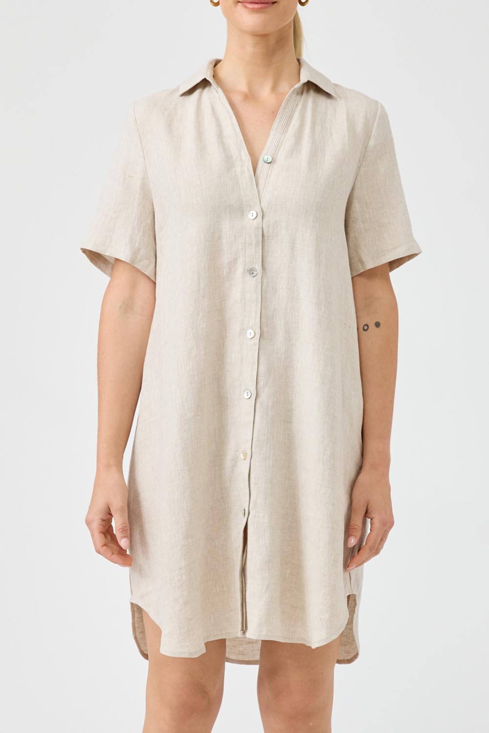 A model wearing the Studio Linen Short Shirt Dress in colour Dune, from the front, cropped image