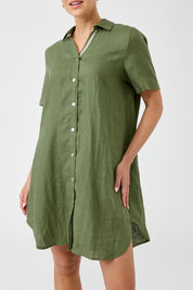 A model wearing the Studio Linen Short Shirt Dress in colour Khaki (Green), from the front, cropped image