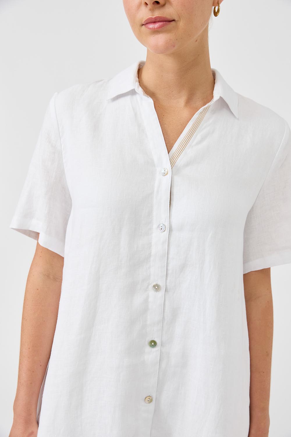 A model wearing the Studio Linen Short Shirt Dress in colour White (White), from the front, cropped image