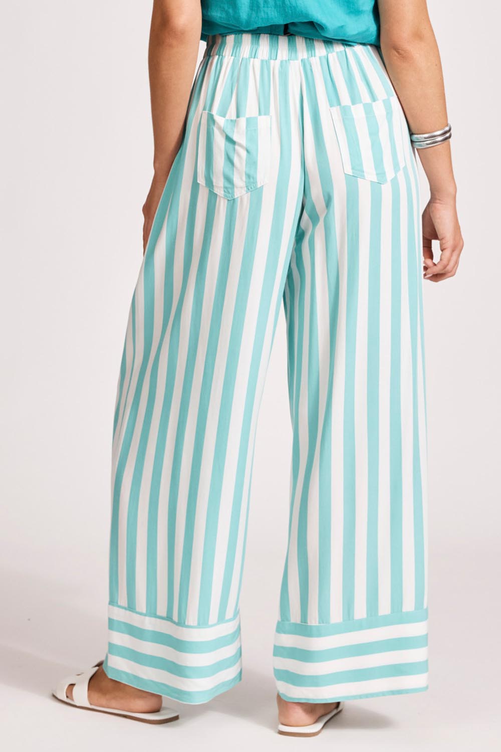 A model wearing the Treville Stripe Pant in colour Aqua (Blue), from the back