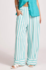 A model wearing the Treville Stripe Pant in colour Aqua (Blue), from the front, cropped image