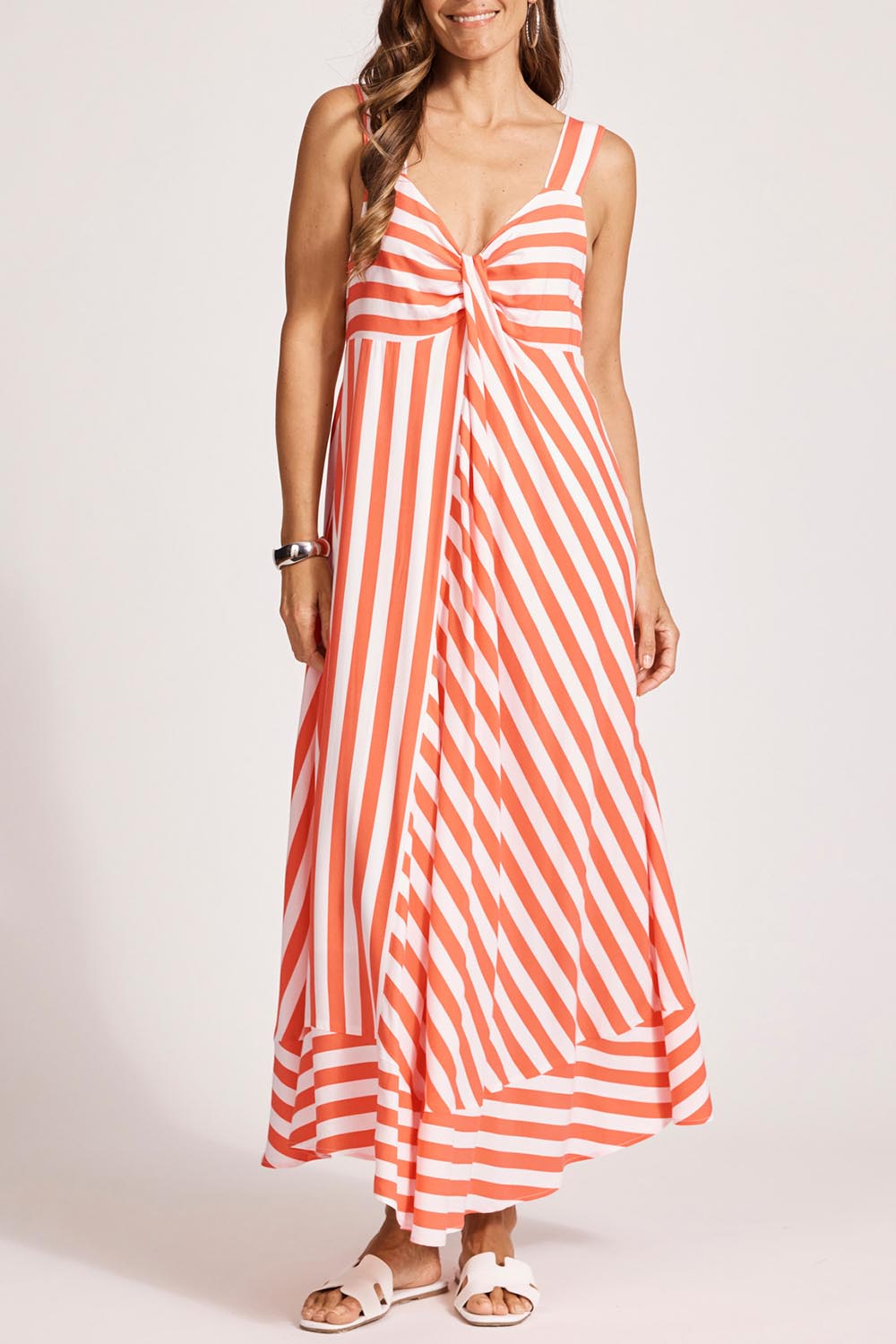 A model wearing the Treville Stripe Tank Maxi Dress in colour Coral (Red), from the front, cropped image