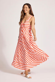 A model wearing the Treville Stripe Tank Maxi Dress in colour Coral (Red), from the front, showing the whole outfit