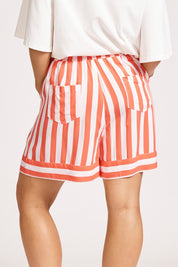 A model wearing the Treville Stripe Short in colour Coral (Red), from the back