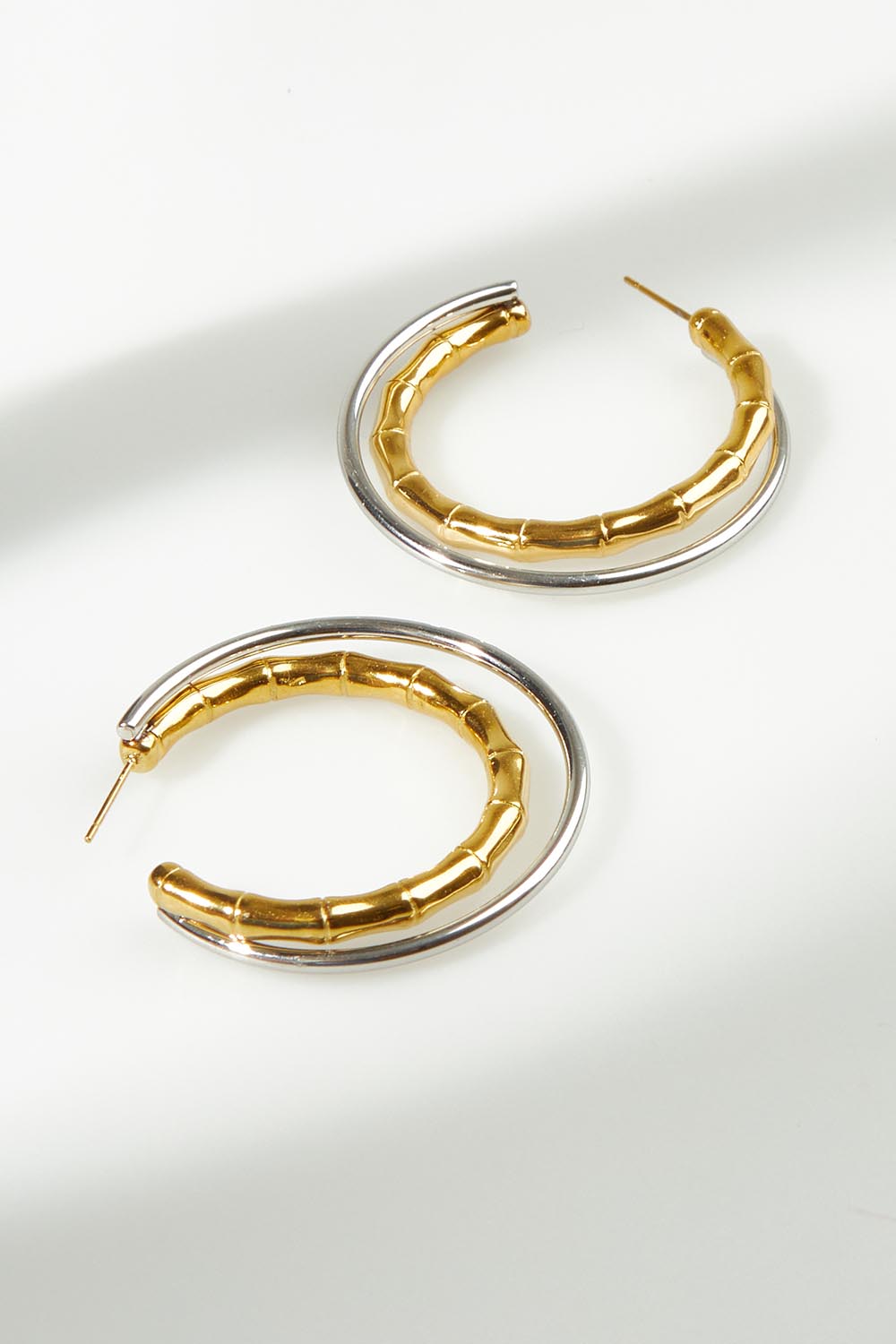 A model wearing the Francia Mixed Hoop Earrings in colour Goldsilver (Metallics), from the front, showing the whole outfit