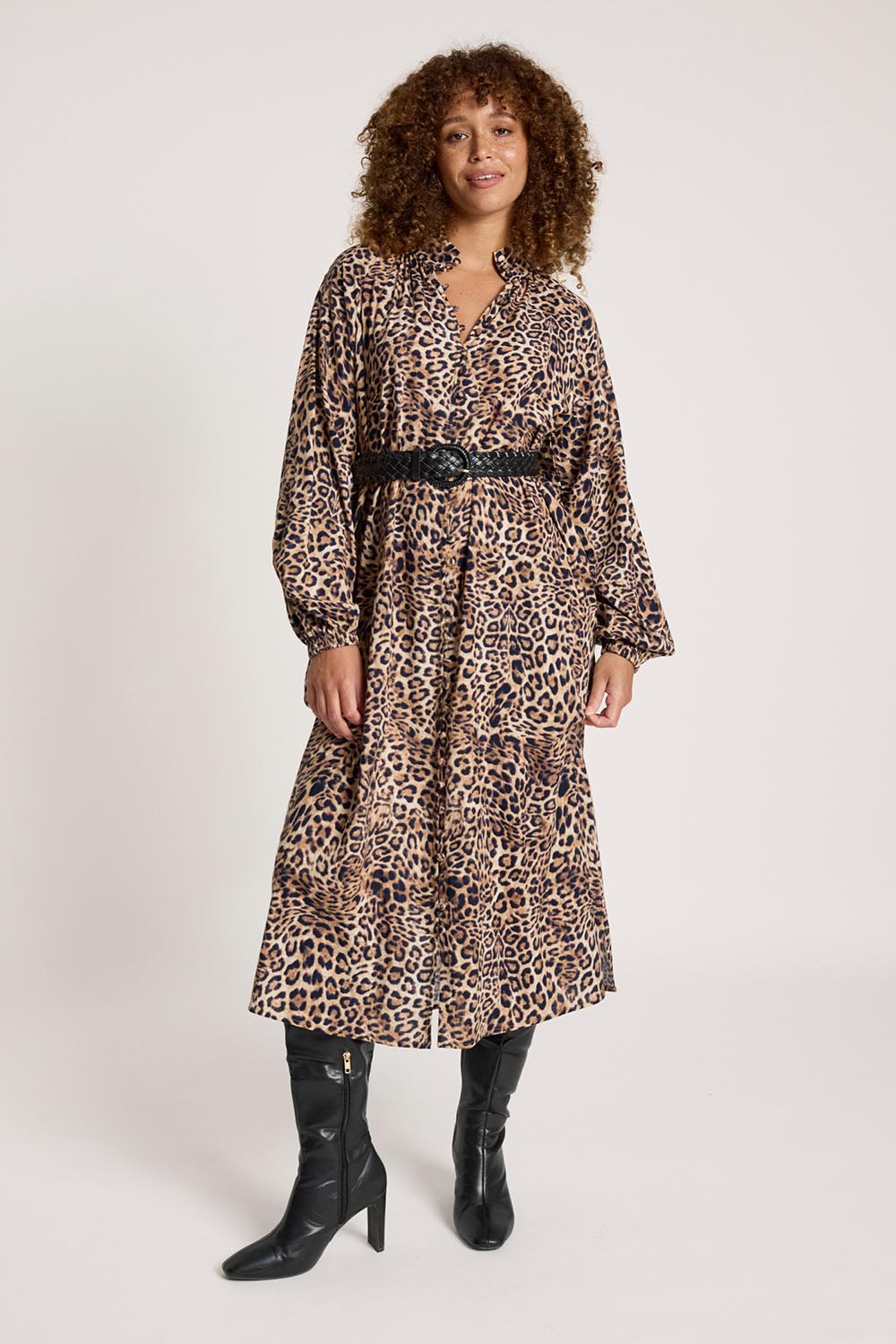 A model wearing the Bajau Button Dress in colour Nomad, from the front, showing the whole outfit