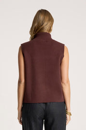 A model wearing the Zala Knit Vest in colour Mahogany (Red), from the back
