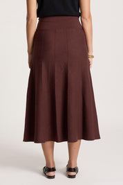 A model wearing the Zala Knit Skirt in colour Mahogany (Red), from the back