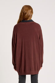 A model wearing the Samira Relaxed Knit in colour Mahogany (Red), from the back