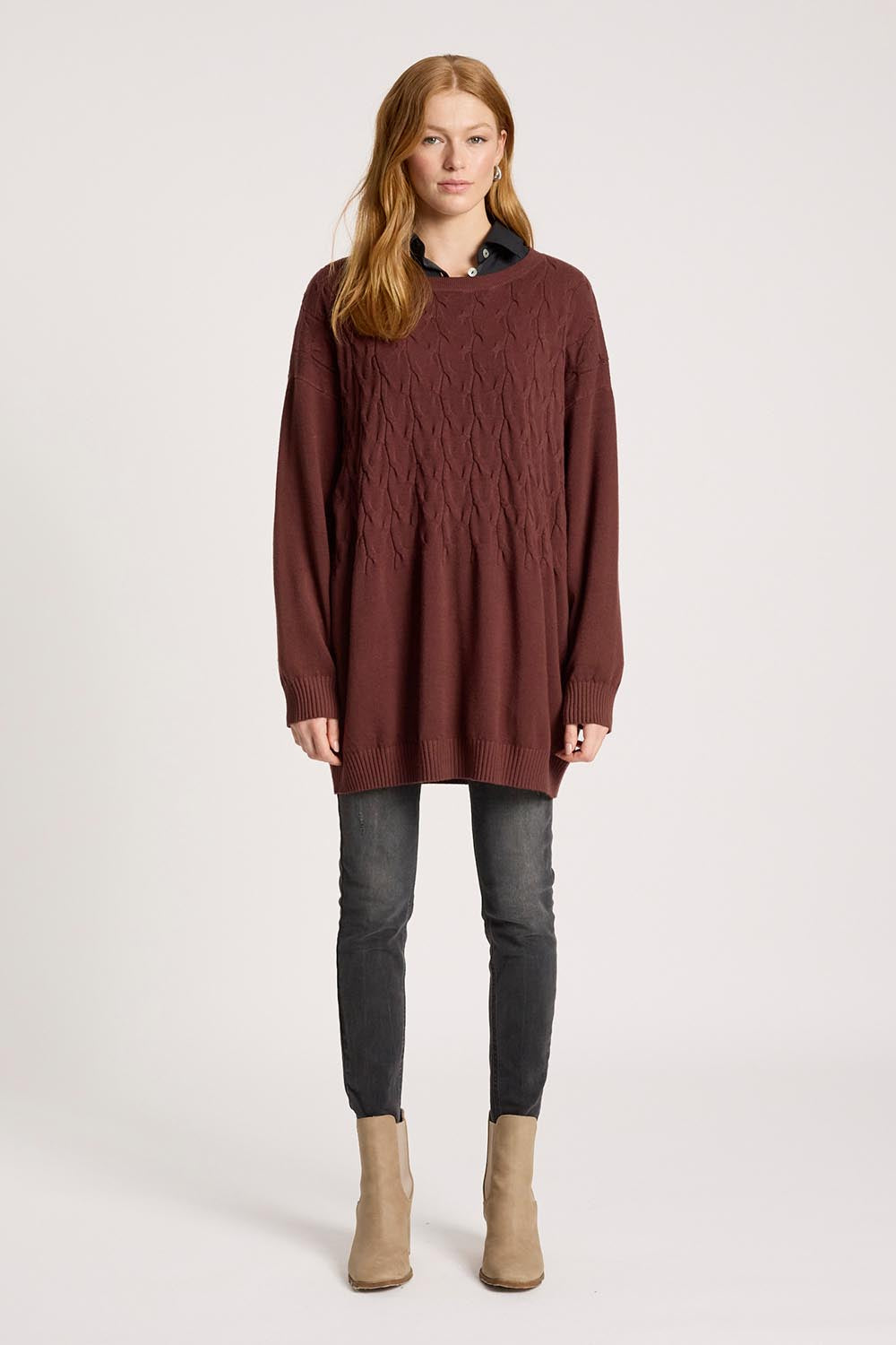 A model wearing the Samira Relaxed Knit in colour Mahogany (Red), from the front, showing the whole outfit