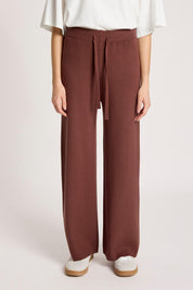 Model Genericm wearing size sample of the Samira Knit Pant - Mahogany in colour Mahogany, in a cropped view