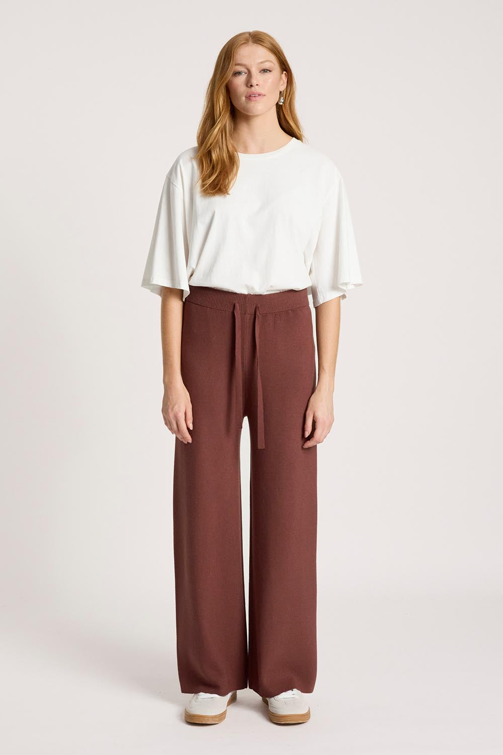Model Genericm wearing size sample of the Samira Knit Pant - Mahogany in colour Mahogany, from the front