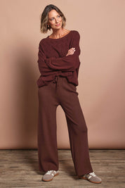 Model Riinar wearing size 10 of the Samira Knit Pant - Mahogany in colour Mahogany, from the front