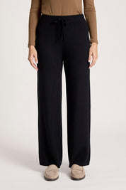 A model wearing the Samira Knit Pant in colour Black (Black), from the front, cropped image
