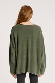 A model wearing the Apache Jumper in colour Pampas (Green), from the back
