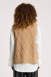 A model wearing the Liora Knit Vest in colour Mocha, from the back