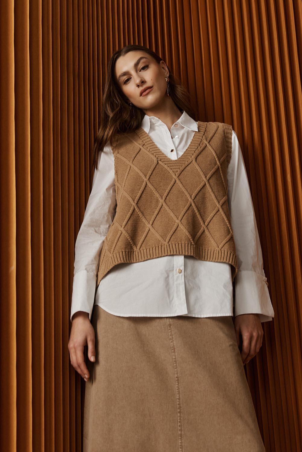 A model wearing the Liora Knit Vest in colour Mocha, from the front, showing the whole outfit