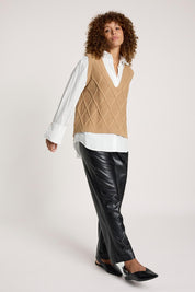 A model wearing the Liora Knit Vest in colour Mocha, from the front, showing the whole outfit