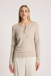 A model wearing the Rumi Long Sleeve Top in colour Bisque, from the front, cropped image