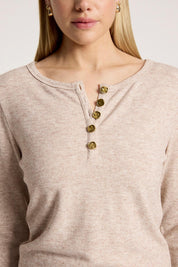 A model wearing the Rumi Long Sleeve Top in colour Bisque, from the front, cropped image