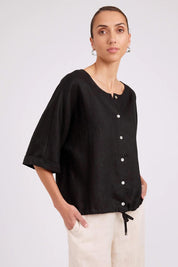 Model Genericm wearing size sample of the Studio Linen Button Top Jacket – Black in colour Black, in a cropped view