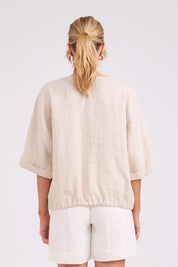 Model Genericm wearing size sample of the Studio Linen Button Top Jacket – Tusk in colour Tusk, from the back