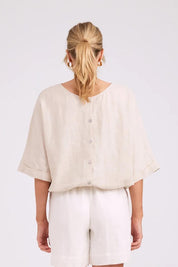Model Genericm wearing size sample of the Studio Linen Button Top Jacket – Tusk in colour Tusk, from the back