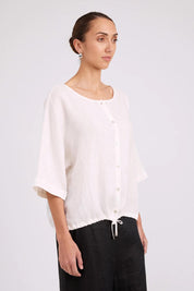 Model Genericm wearing size sample of the Studio Linen Button Top Jacket – White in colour White, from an angle