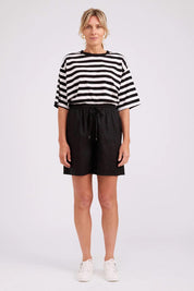 Model Genericm wearing size sample of the Studio Linen Bermuda Short – Black in colour Black, from the front