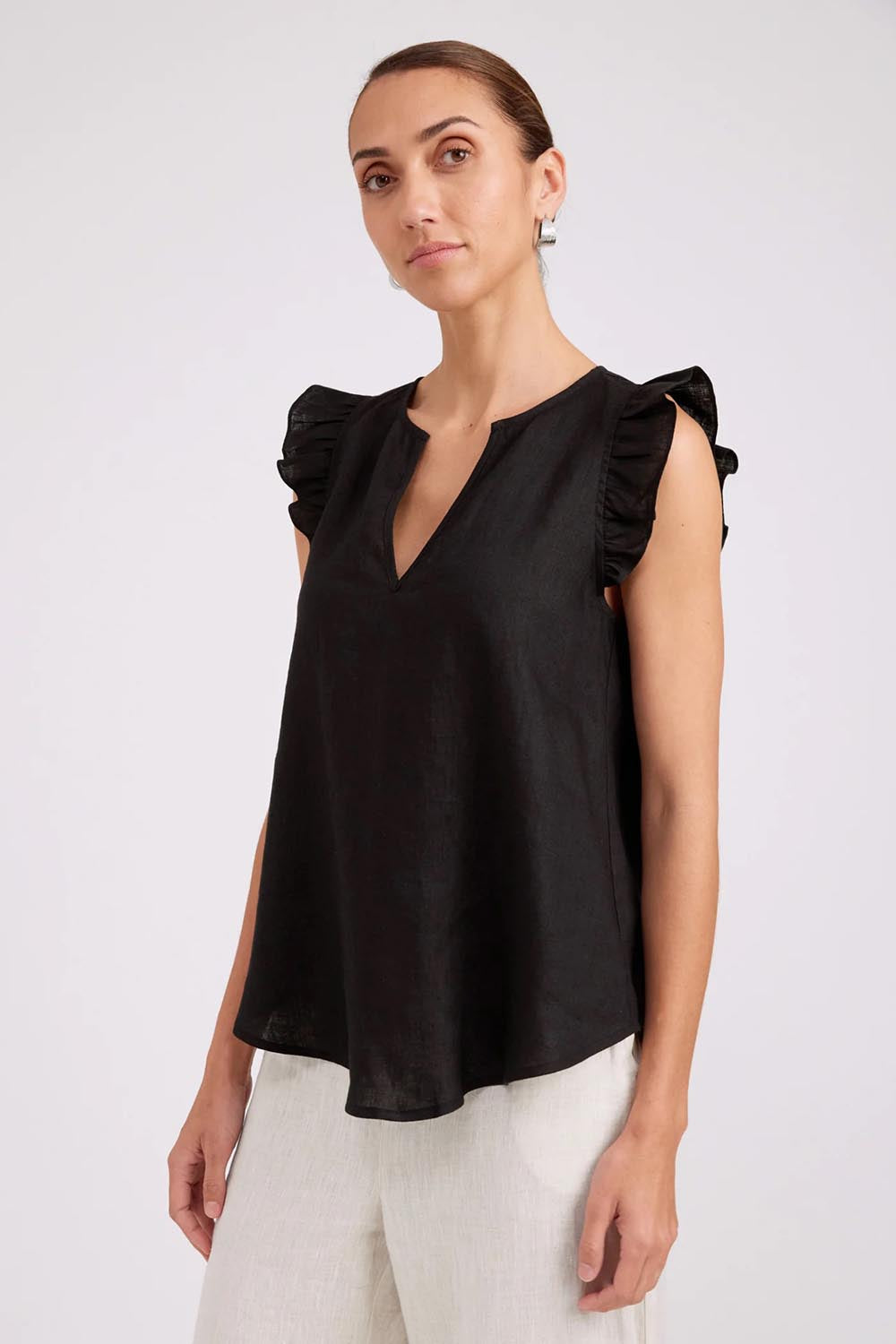 Model Genericm wearing size sample of the Studio Linen Frill Tank – Black in colour Black, in a cropped view