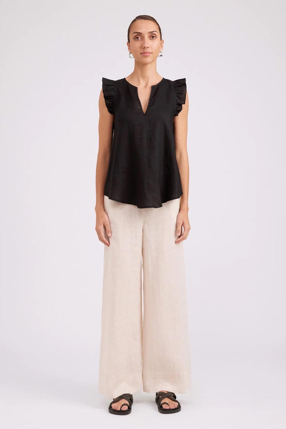 Model Genericm wearing size sample of the Studio Linen Frill Tank – Black in colour Black, from the front