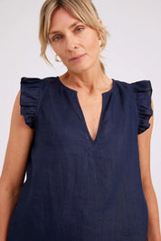 Model Genericm wearing size sample of the Studio Linen Frill Tank – Navy in colour Navy, in a cropped view