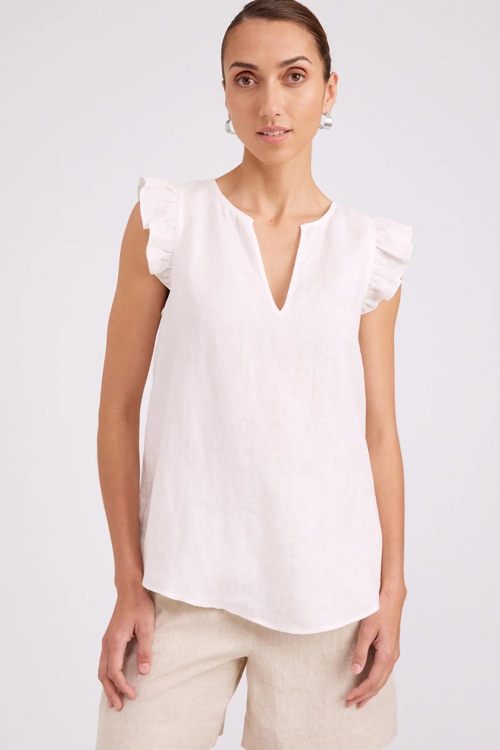 Model Genericm wearing size sample of the Studio Linen Frill Tank – White in colour White, in a cropped view