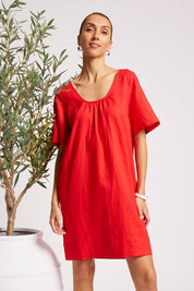 Model Genericm wearing size sample of the Cove Dress – Aperol in colour Aperol, in a cropped view