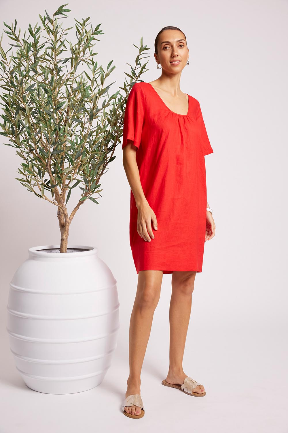 Model Genericm wearing size sample of the Cove Dress – Aperol in colour Aperol, from the front