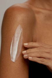A model wearing the Coconut Body Milk in colour Milk (White), from the front, showing the whole outfit