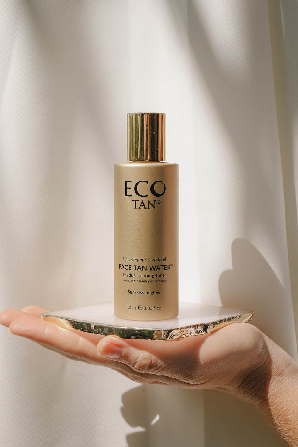 A model wearing the Face Tan Water in colour Tan, from the front, showing the whole outfit