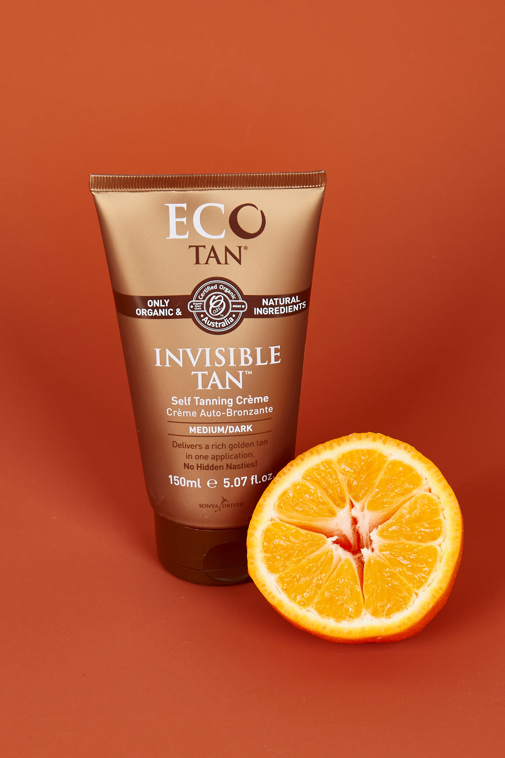 A model wearing the Organic Invisible Tan in colour Naturals, from the front, showing the whole outfit