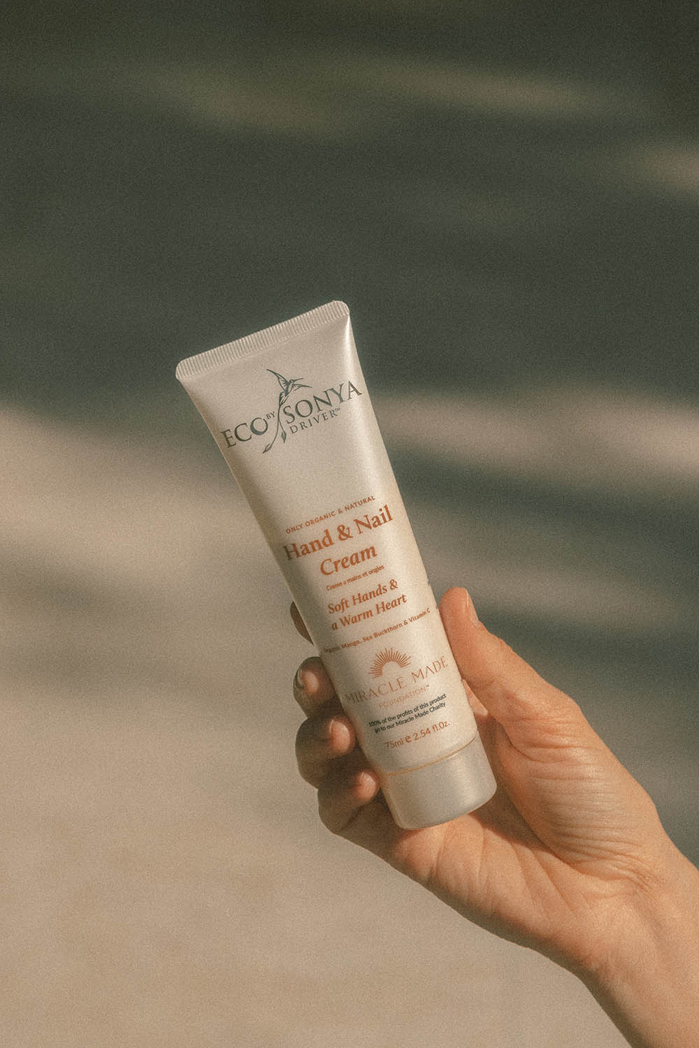 A model wearing the Hand & Nail Cream in colour Natural, from the front, showing the whole outfit