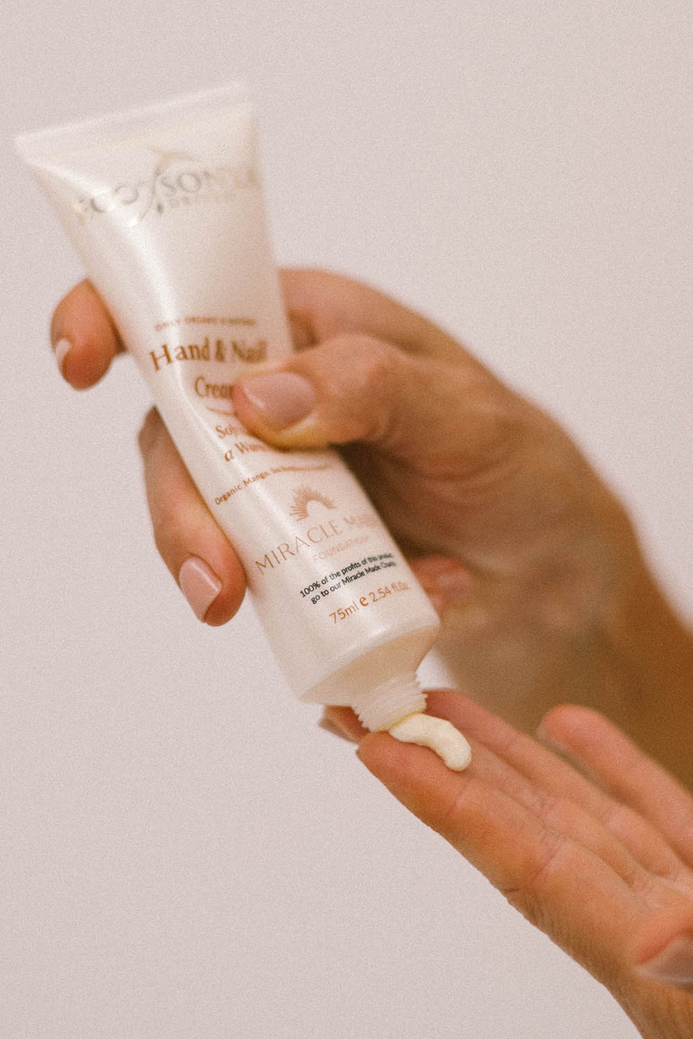 A model wearing the Hand & Nail Cream in colour Natural, from the front, showing the whole outfit