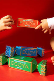 A model wearing the Mini Hand Cream Bon Bon in colour Freshpine (Green), from the front, showing the whole outfit