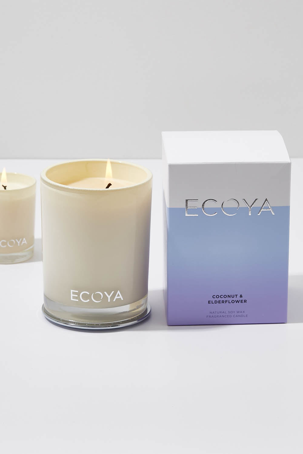 A model wearing the Madison Jar Coconut And Elderflower Candle in colour Coconut, from the front, showing the whole outfit